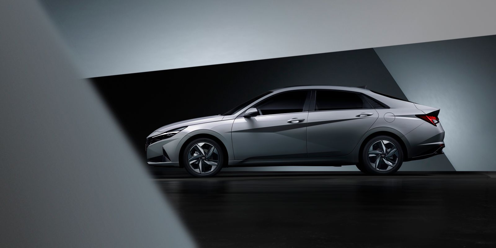 A silver sedan photographed against a clean studio background