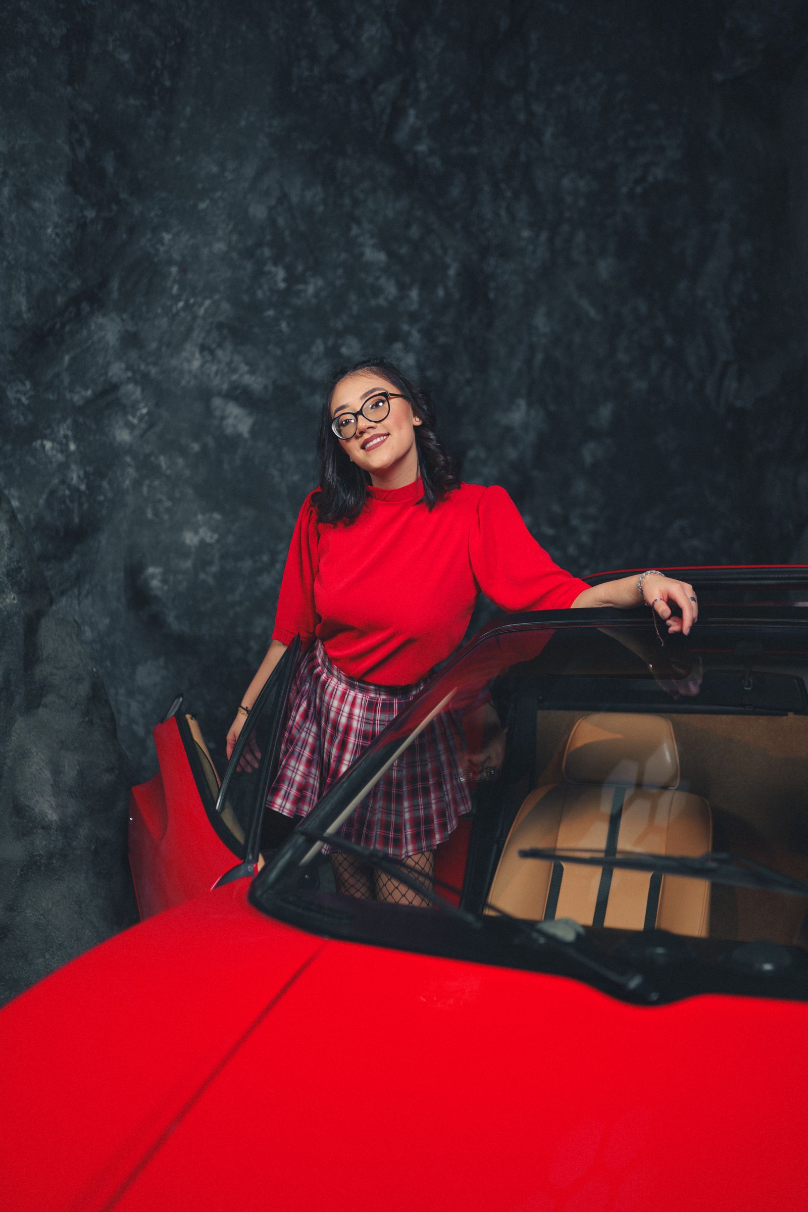 A driver standing beside her newly delivered lease car