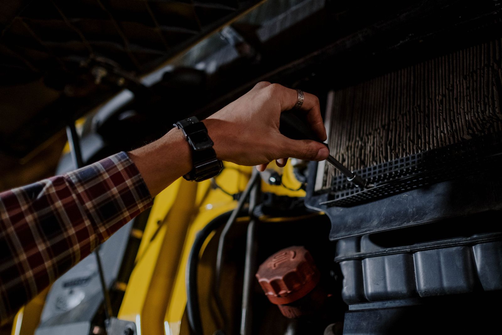 A technician inspecting a trade-in vehicle